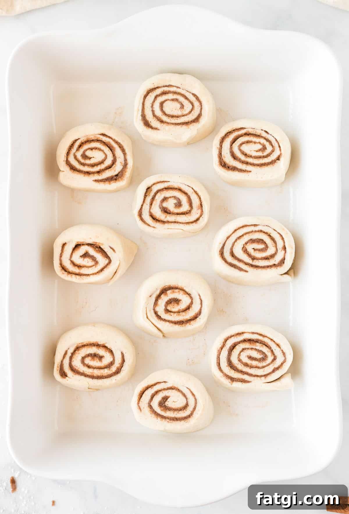 cinnamon rolls raw in the baking dish