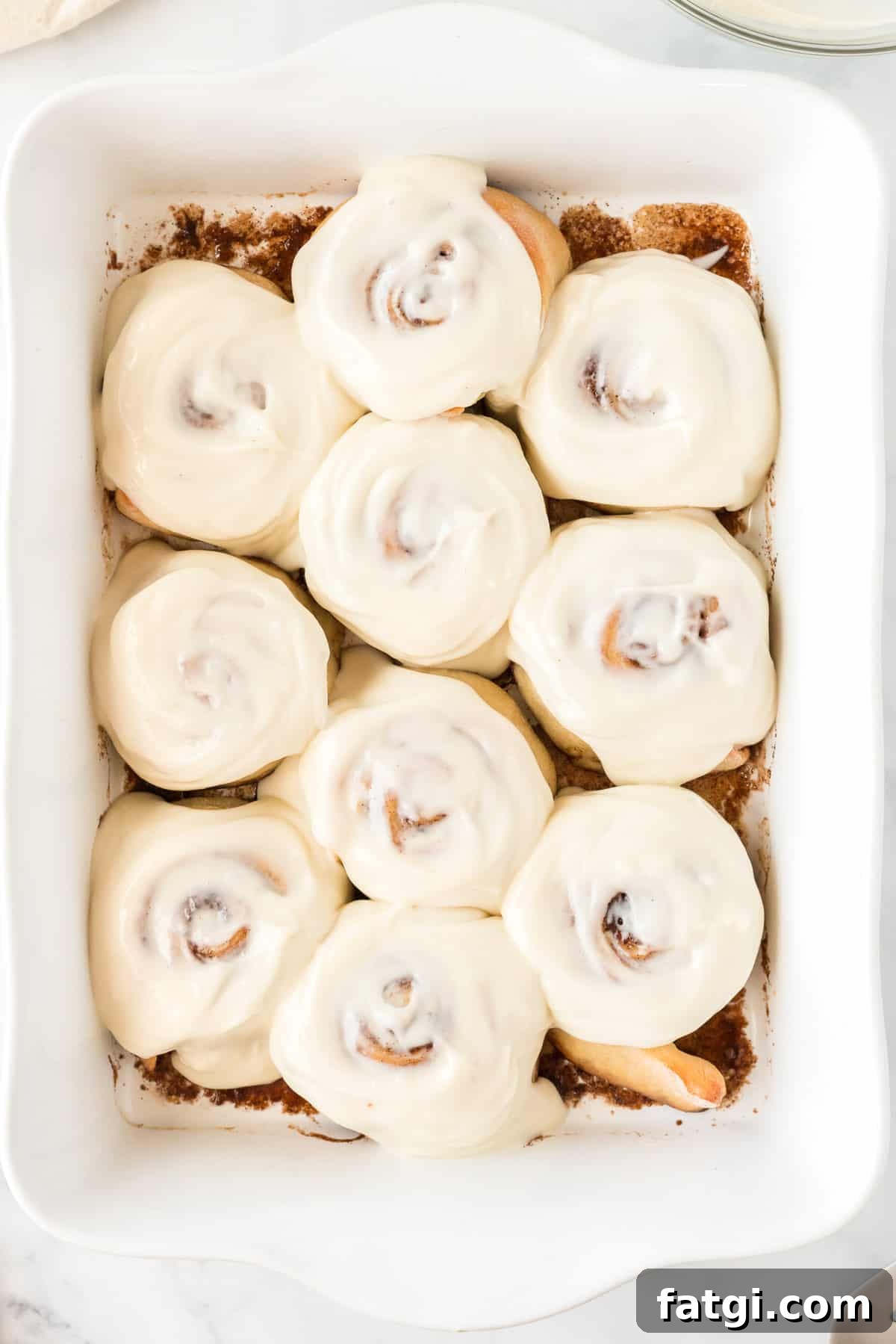 cinnamon rolls spread with cream cheese icing