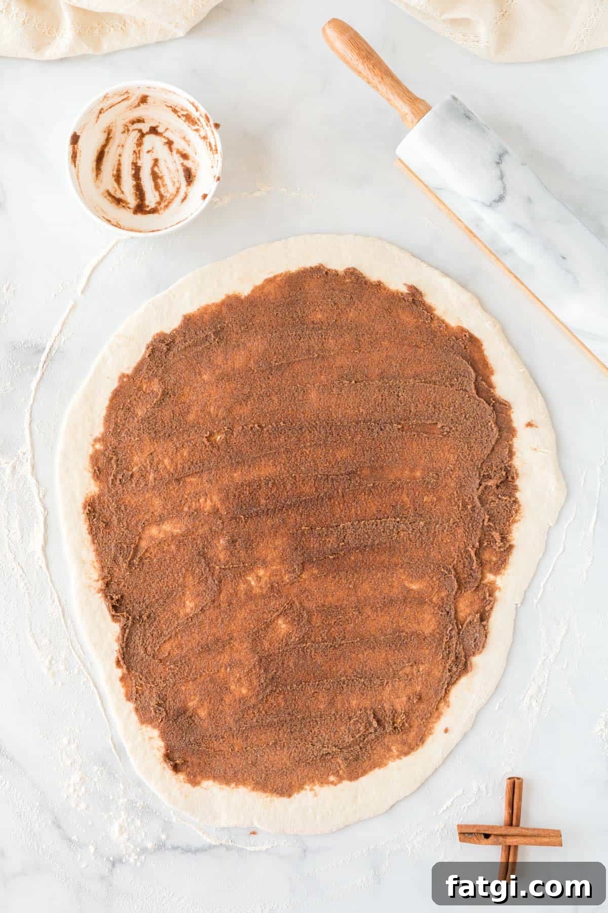 dough rolled out and covered with cinnamon sugar