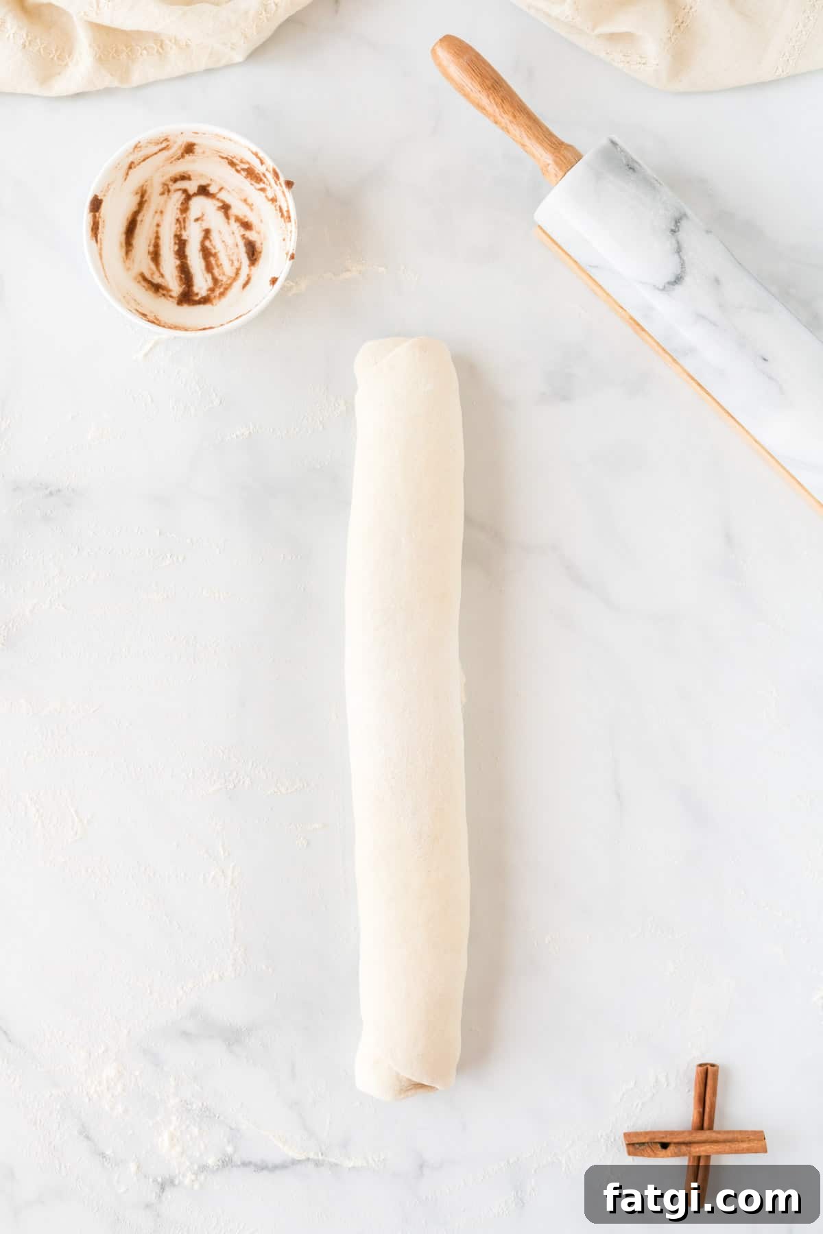 cinnamon roll dough rolled into a log shape