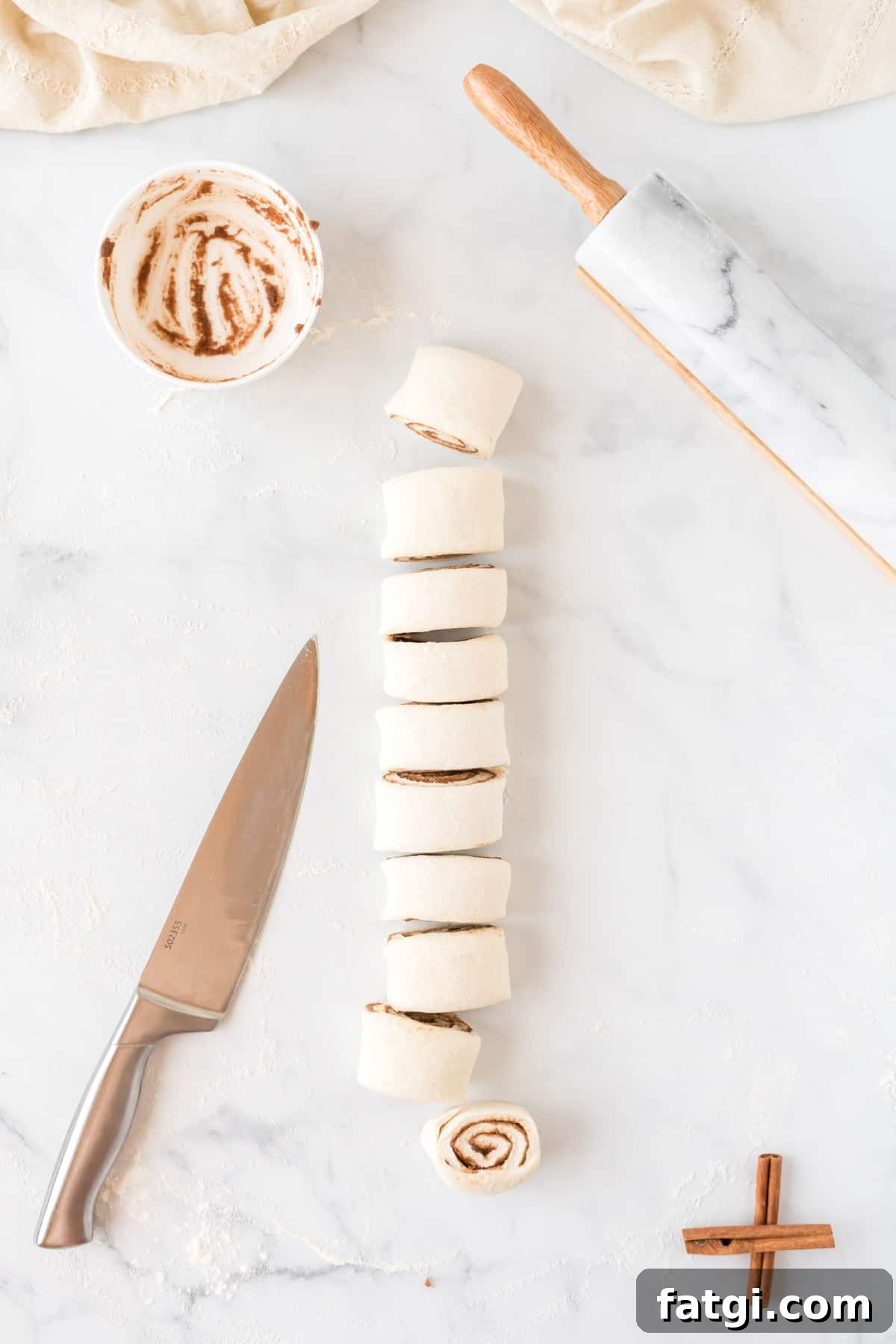 cinnamon roll dough rolled into a log shape and cut into pieces