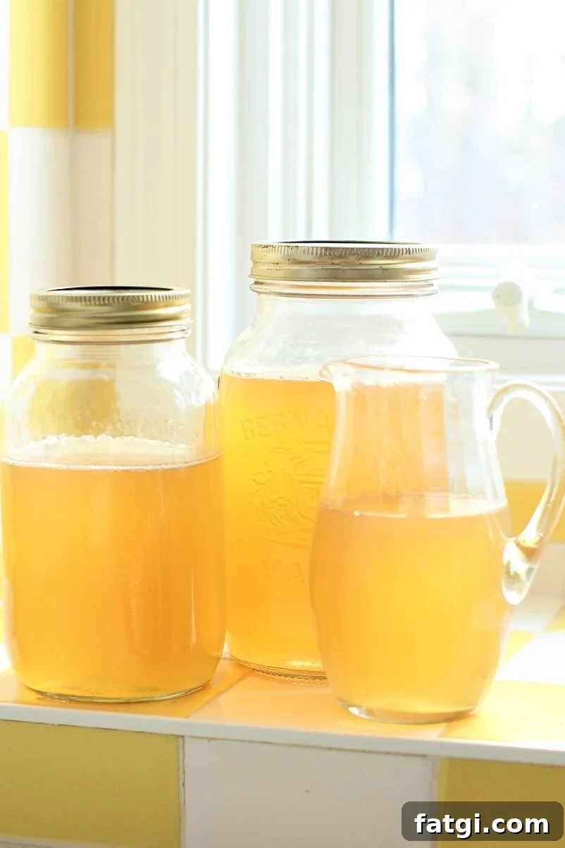jars of Instant Pot Chicken Stock in the windowsill