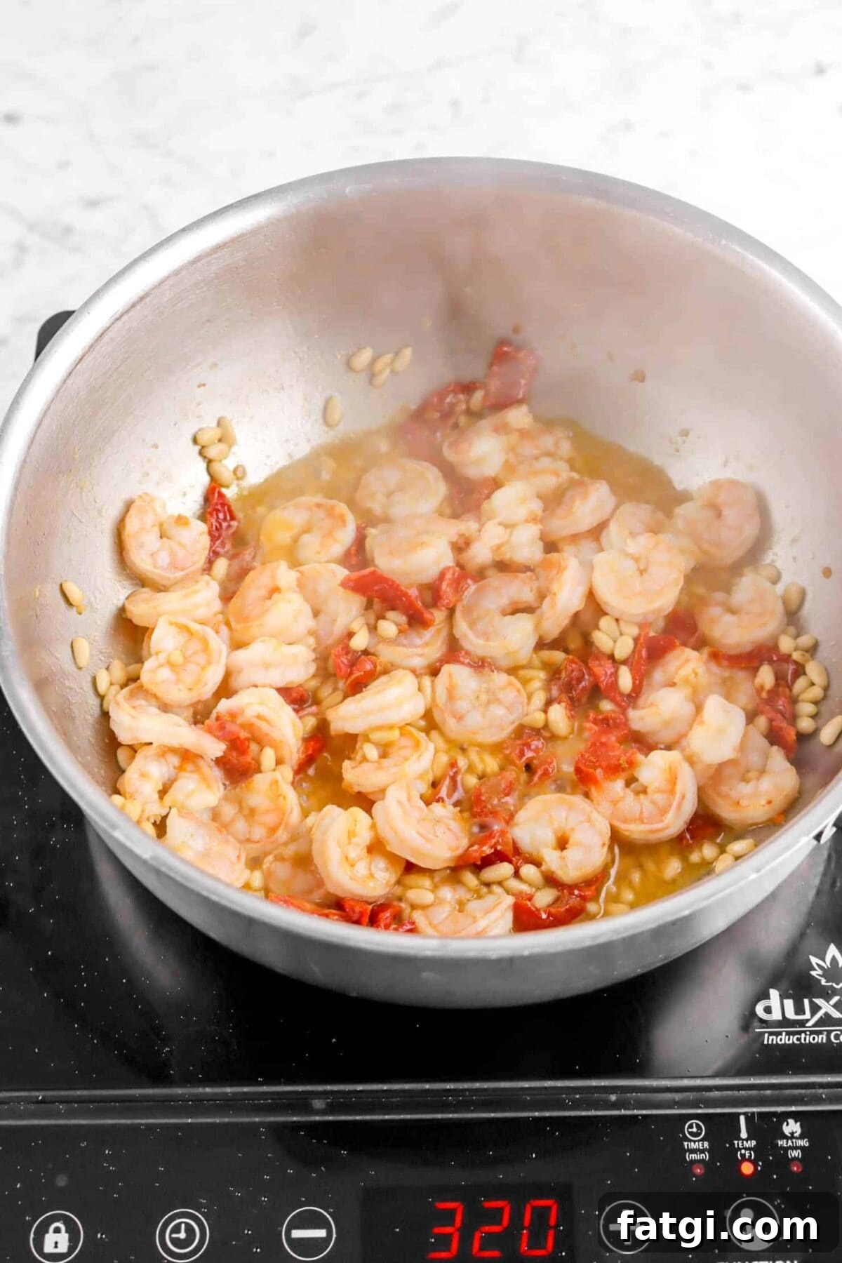 cooked shrimp with pine nuts and sun dried tomatoes