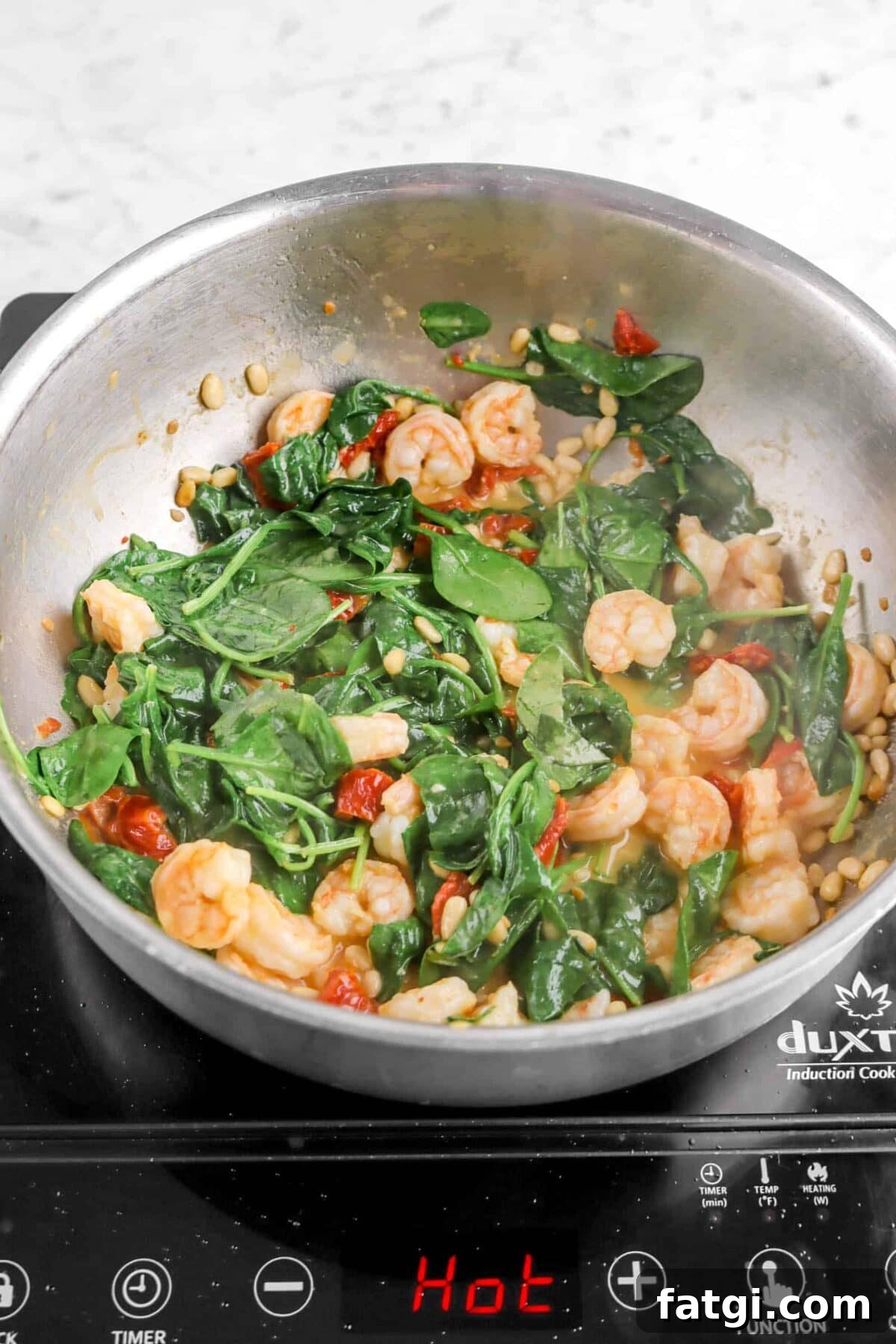 wilted spinach mixed with shrimp