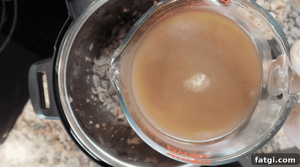 Adding broth to pot
