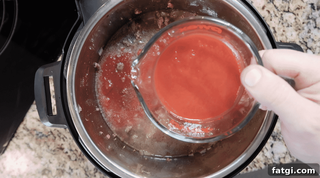 Adding tomato sauce to pot