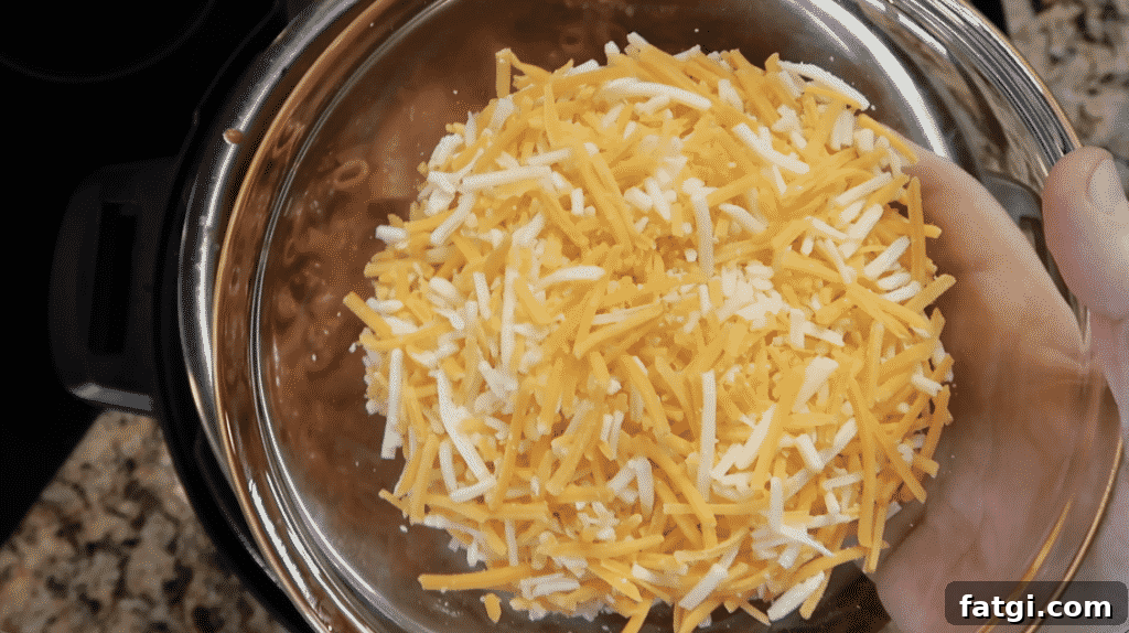 Adding cheese to pot.