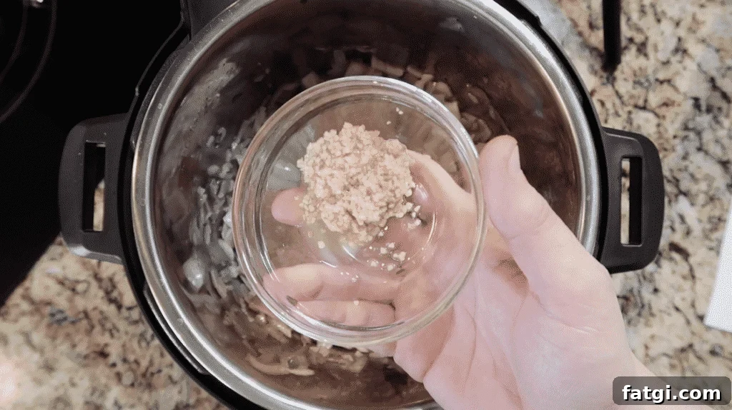 Adding garlic to pot.