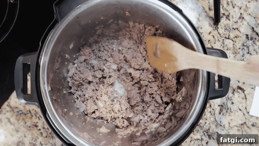 Crumbling and sautéing meat.