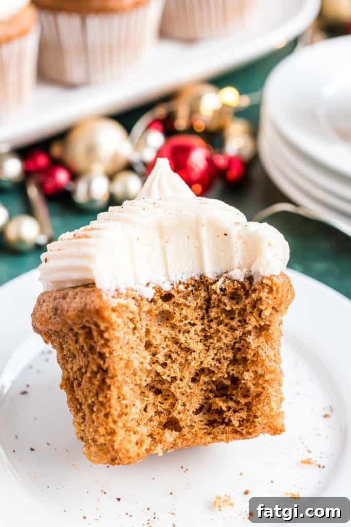 Bite taken out of a gingerbread cupcake.
