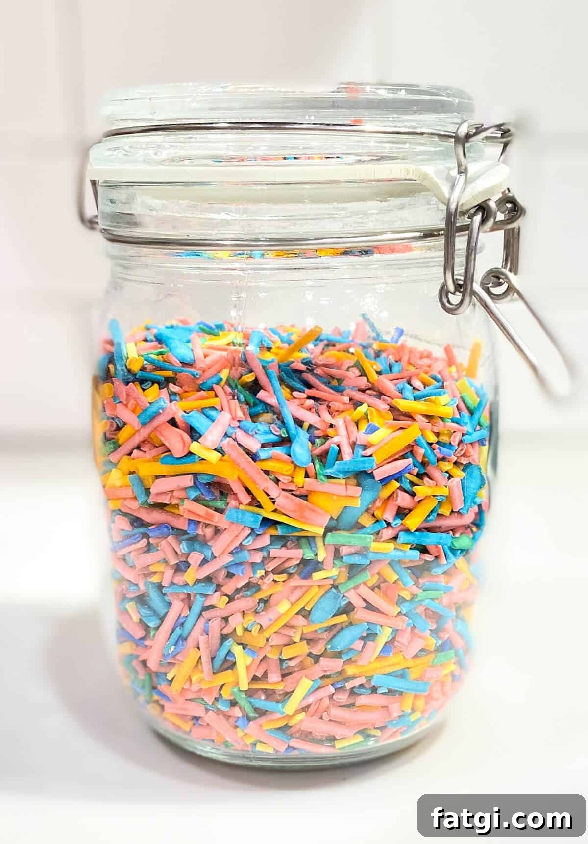 A large glass jar, filled with sprinkles.