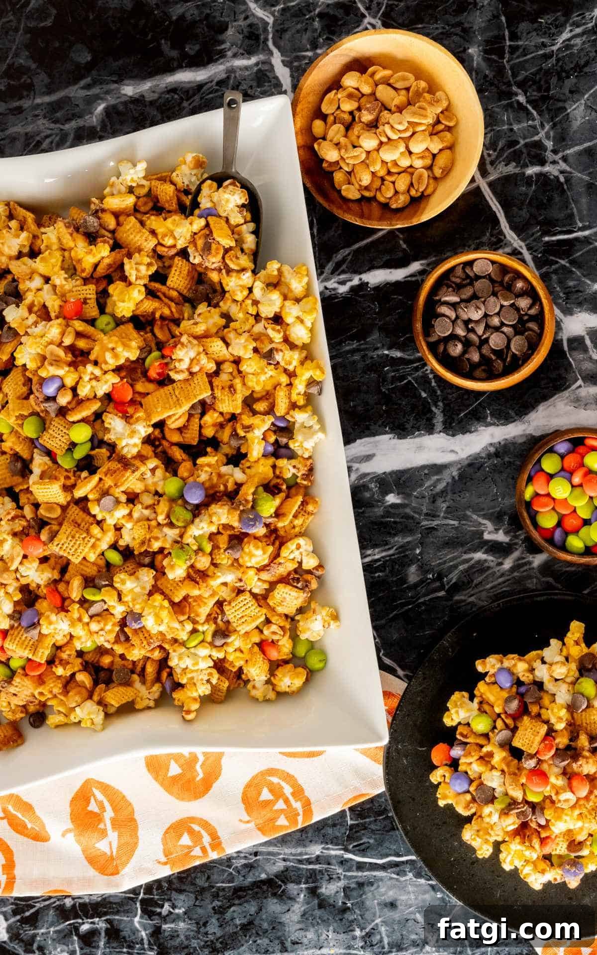 Halloween monster munch mixture with pumpkin linen napkins.