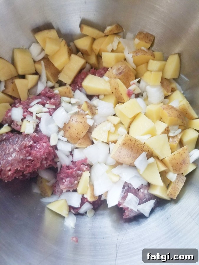 meat potatoes and onions in mixing bowl