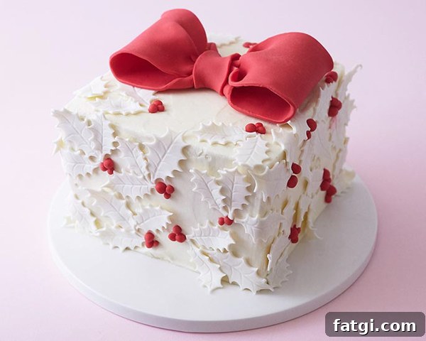 Holiday gift box cake decorated with holly leaves
