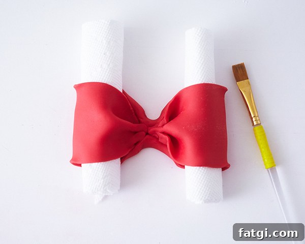 Fondant bow supported with paper towels while drying
