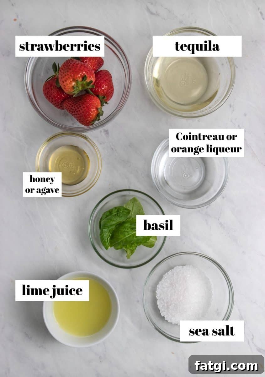 Strawberries, basil, sea salt, honey and other ingredients to make cocktail.