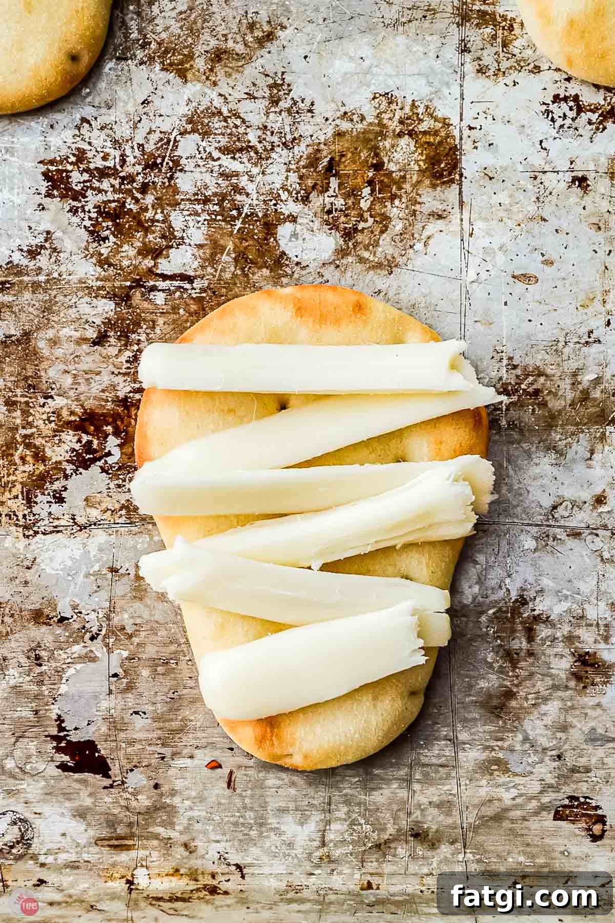 Mini Mummy Pizza Dippers for Halloween 5 slices of cheese on naan dippers