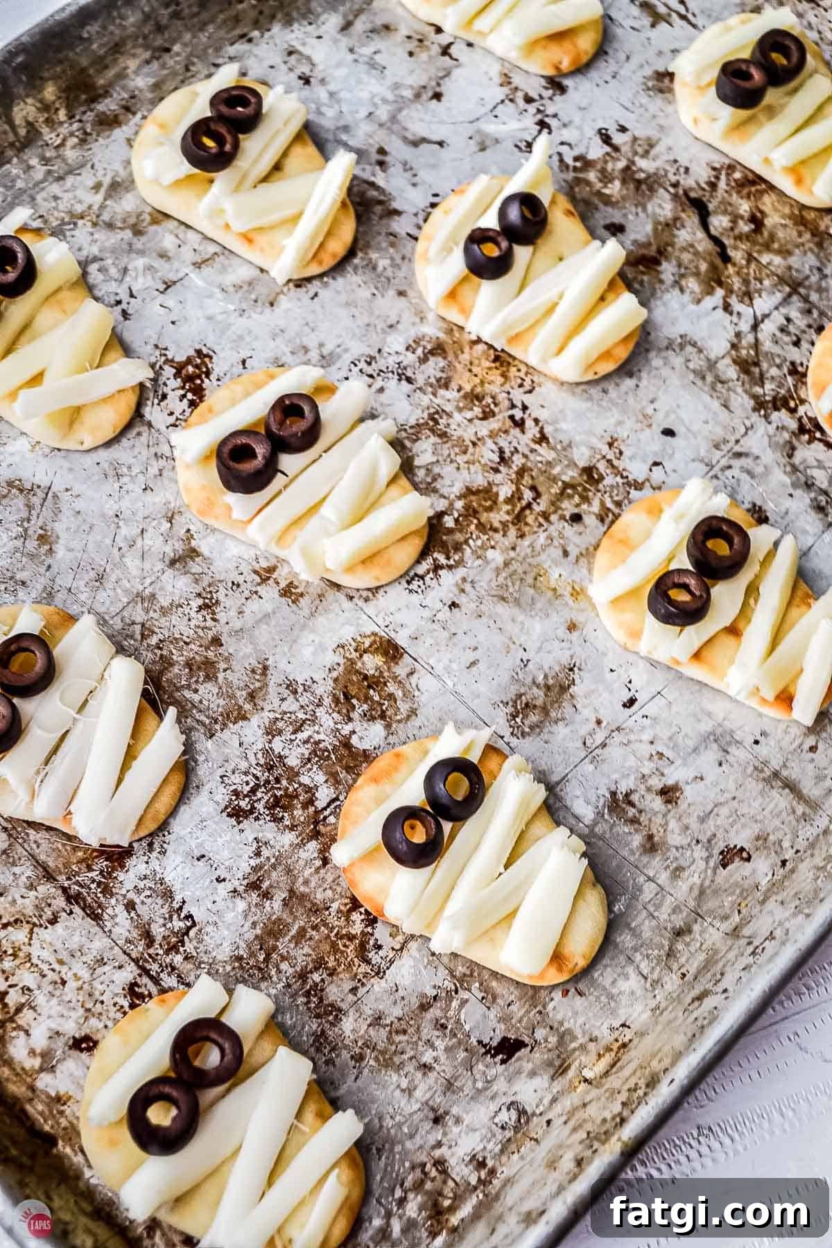 Mini Mummy Pizza Dippers for Halloween 7 lots of tiny mummy pizzas on a baking sheet