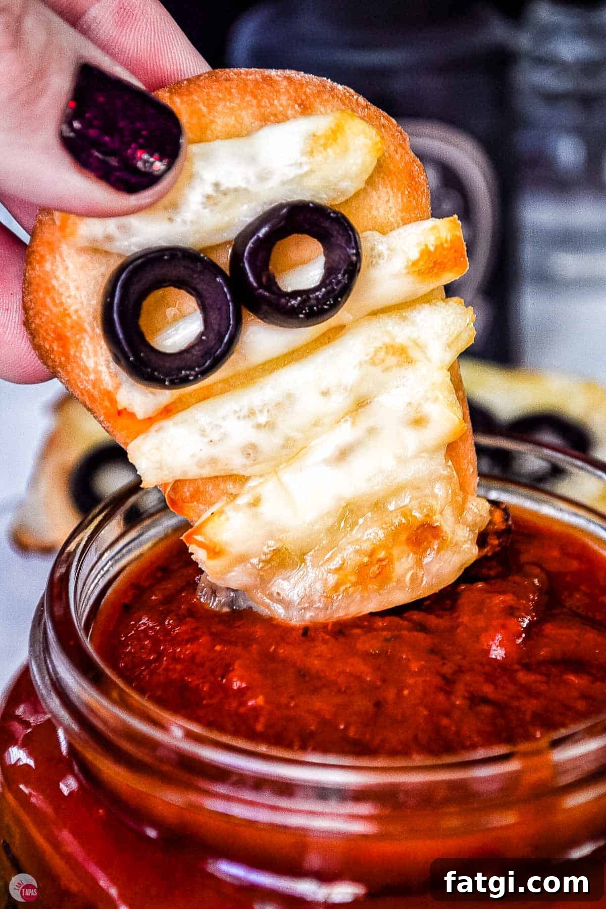 Mini Mummy Pizza Dippers for Halloween 9 naan mummy dipping into sauce