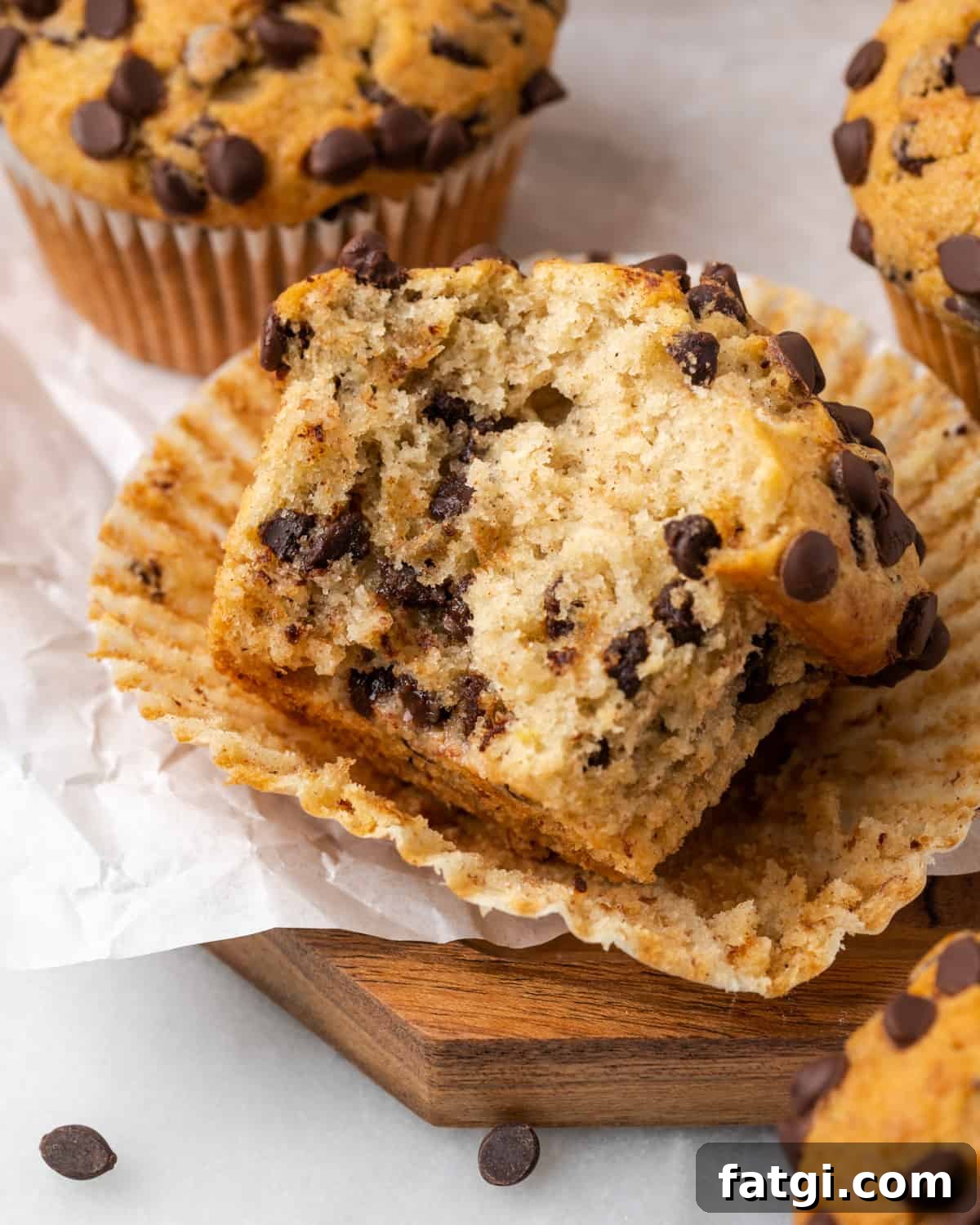 A gluten free banana chocolate chip muffin with a bite taken out of the side. 