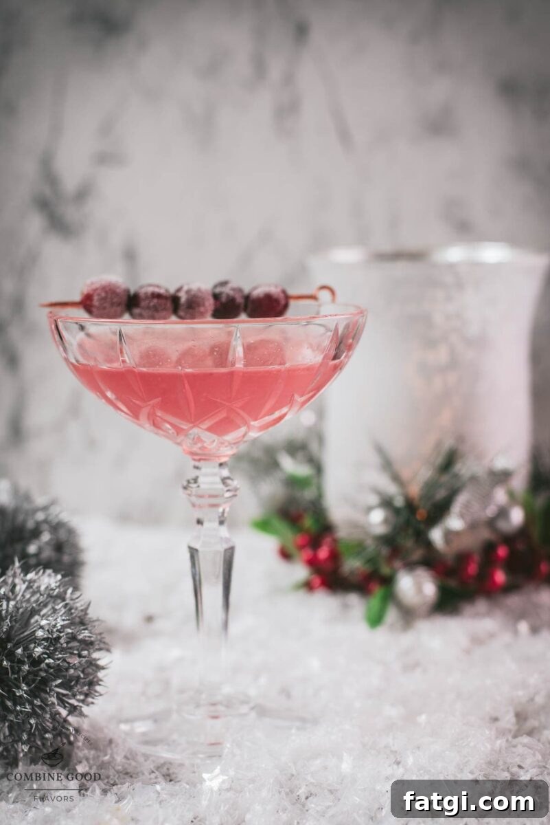 Cranberry Maraschino Sour Cocktail Recipe 12 Gorgeous pink cranberry maraschino sour garnished with iced cranberries on a cocktail skewer.