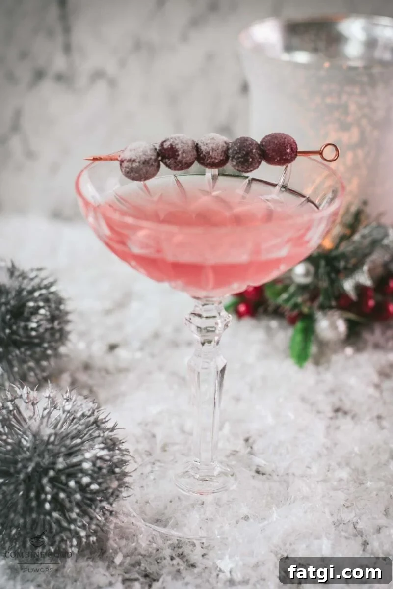 Cranberry Maraschino Sour Cocktail Recipe 13 Gorgeous pink cranberry maraschino sour garnished with iced cranberries on a cocktail skewer.