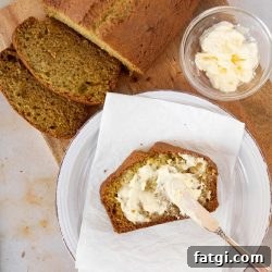 Overhead shot of a loaf of zucchini bread with a slice being spread with clotted cream and text Zucchini Sweet Bread, recipes and ideas using zucchini
