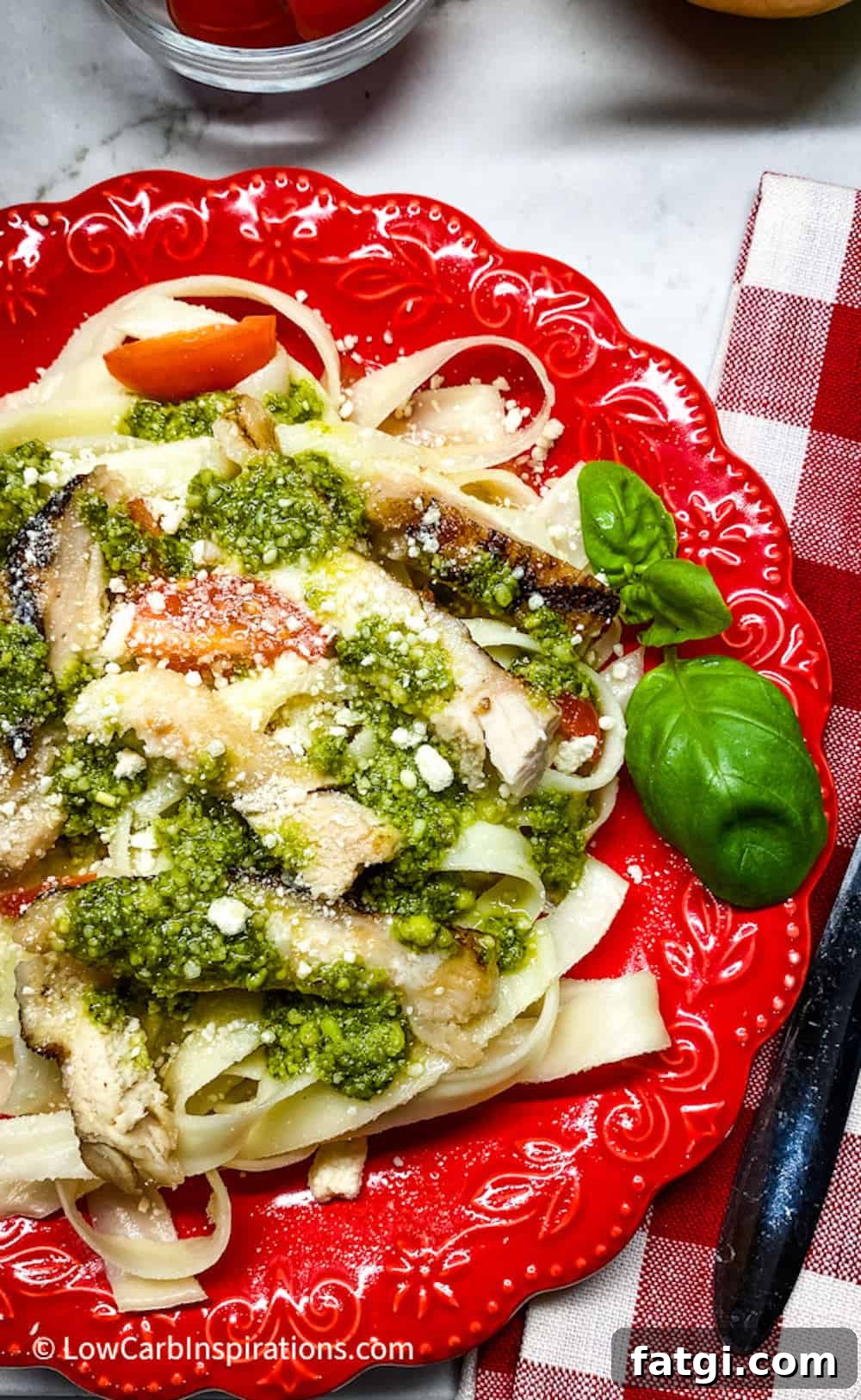 Keto pasta noodles served on a red plate.