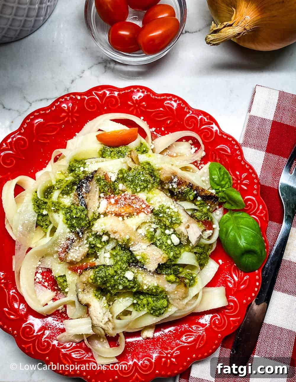 Keto pasta served on a red plate includes a gingam red napkin