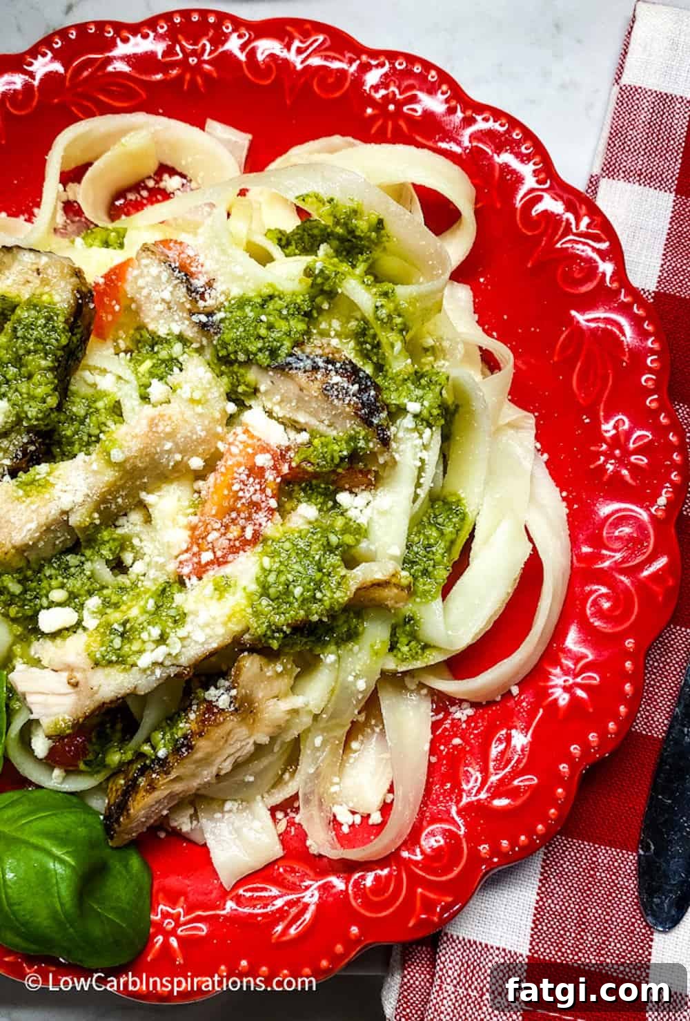Keto noodles served on a red plate with chicken close up photo