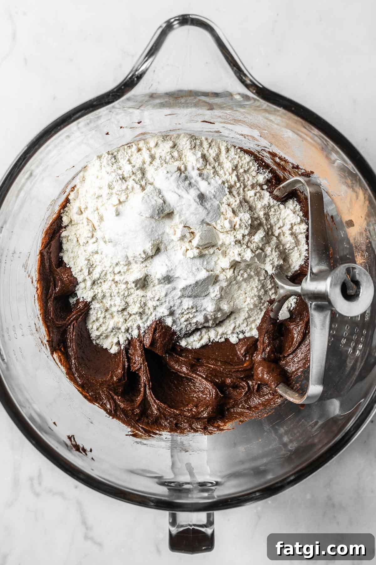 Dry ingredients added to wet chocolate cookie dough.
