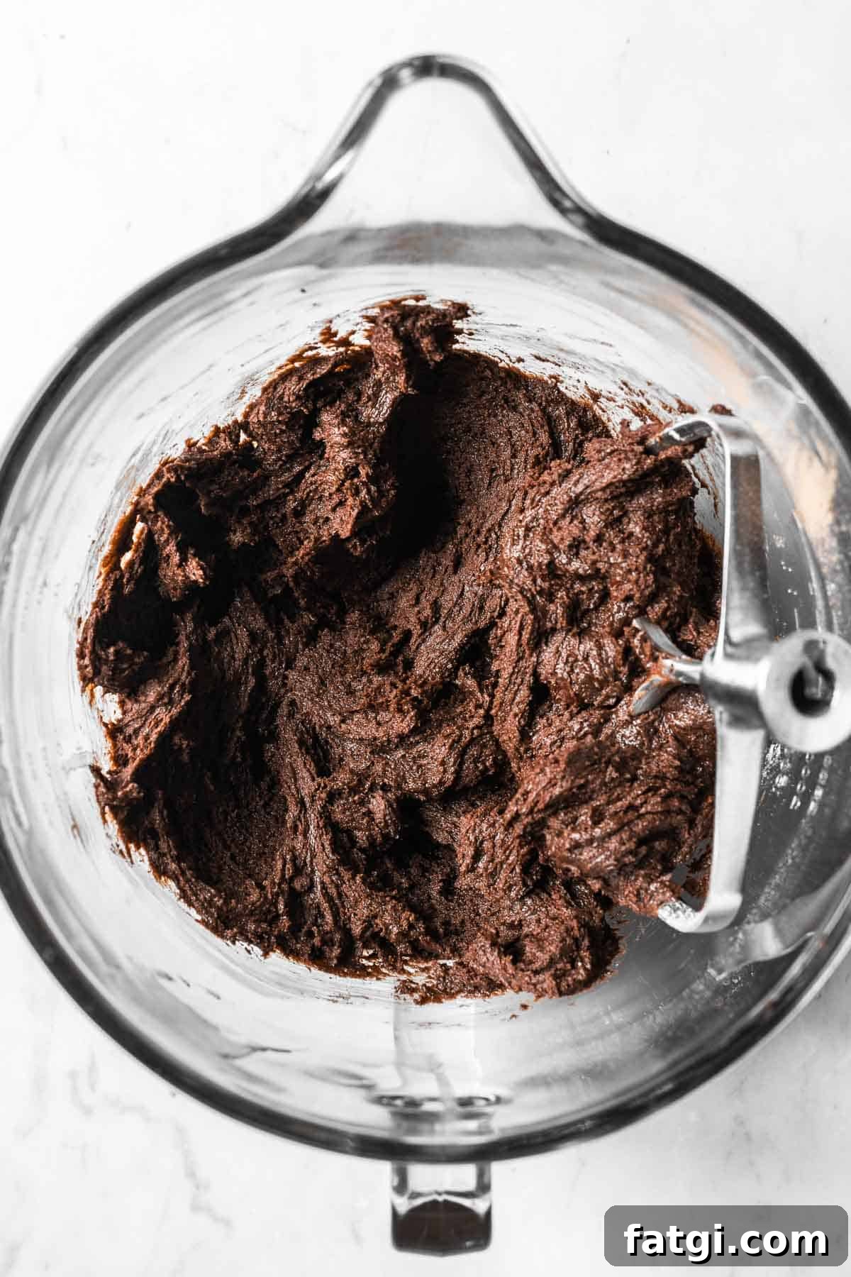 Chocolate mascarpone cookie dough in a glass mixing bowl.
