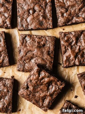 Double chocolate chip cookie bar squares on brown parchment paper.