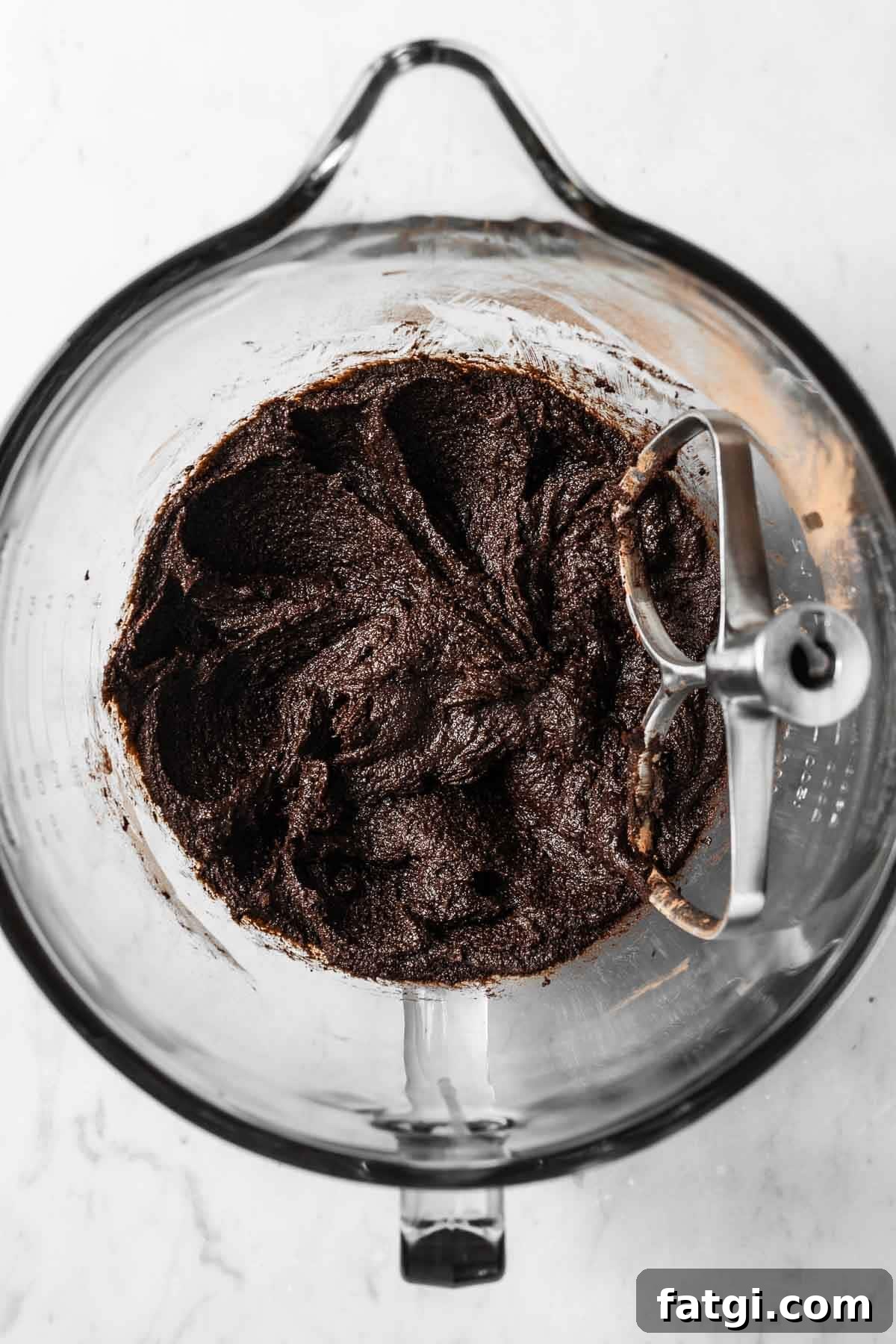 Melted butter, brown sugar and cocoa powder in a glass mixing bowl.