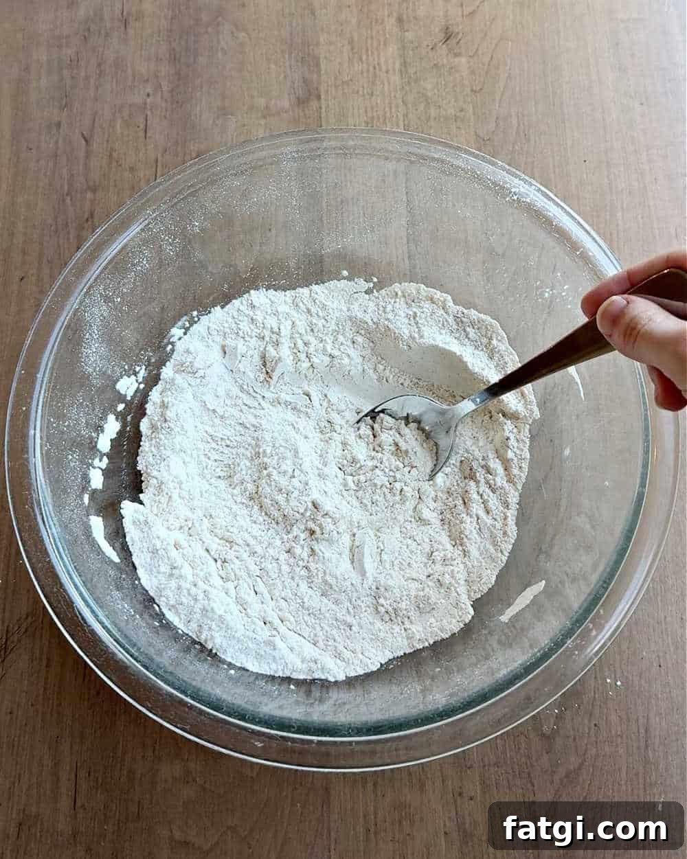 mixing dry ingredients with spoon.