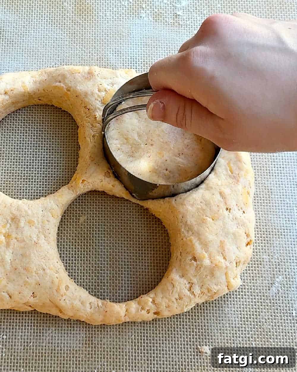 cutting dough with biscuit cutter.