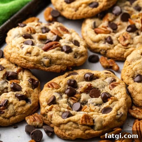 Closeup of pecan chocolate chip cookies on a baking tray.