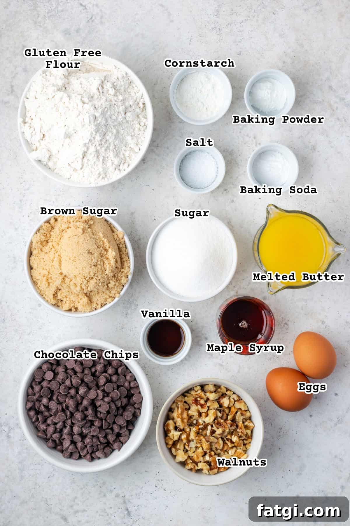Ingredients for gluten free walnut chocolate chip cookies on a white table.