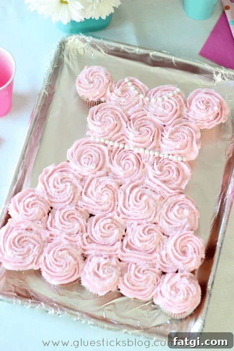 Fun Cake Recipes Kids Can Make at Home 11 Cupcakes arranged in the shape of a dress and frosted with pink frosting.