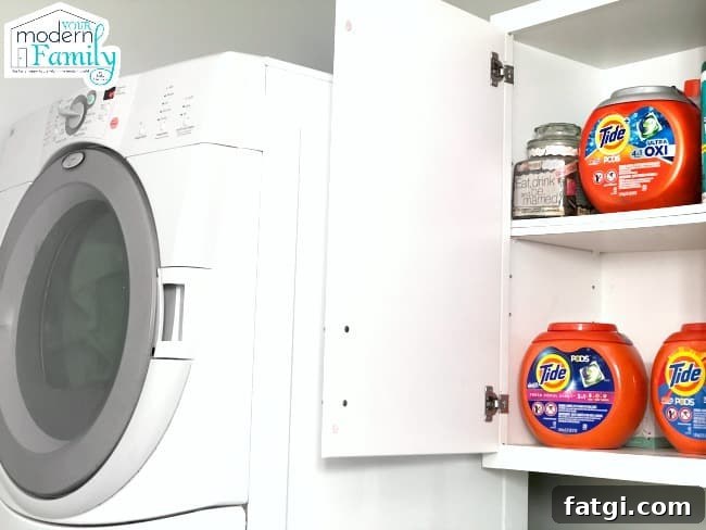 A close up of a laundry room cabinet with a variety of Tide products on the shelf.