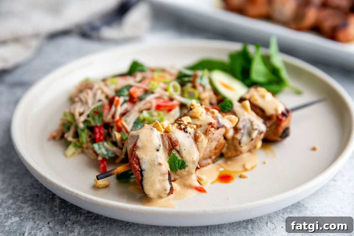 Juicy Marinated Pork Kebabs with Peanut Noodle Salad 2 Grilled pork kebabs served over peanut noodle salad with fresh herbs and peanut dressing