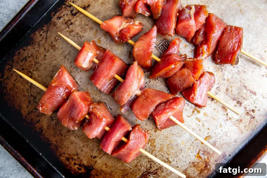 Juicy Marinated Pork Kebabs with Peanut Noodle Salad 6 Raw marinated pork threaded onto skewers, ready for grilling