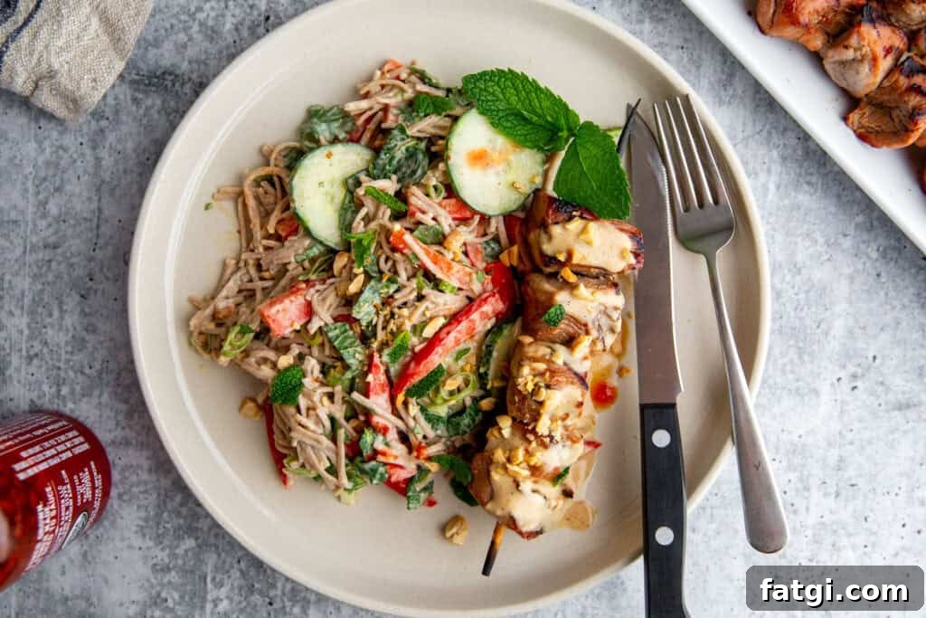 Juicy Marinated Pork Kebabs with Peanut Noodle Salad 9 Juicy grilled pork kebabs arranged on soba noodle salad, ready to serve