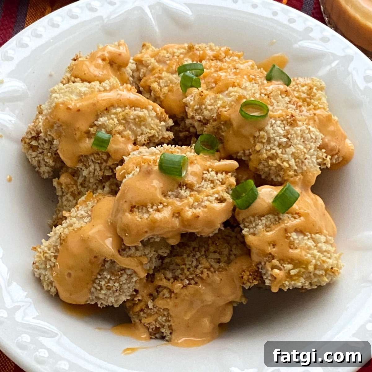 Healthy bang bang chicken that was baked in the oven in a bowl.