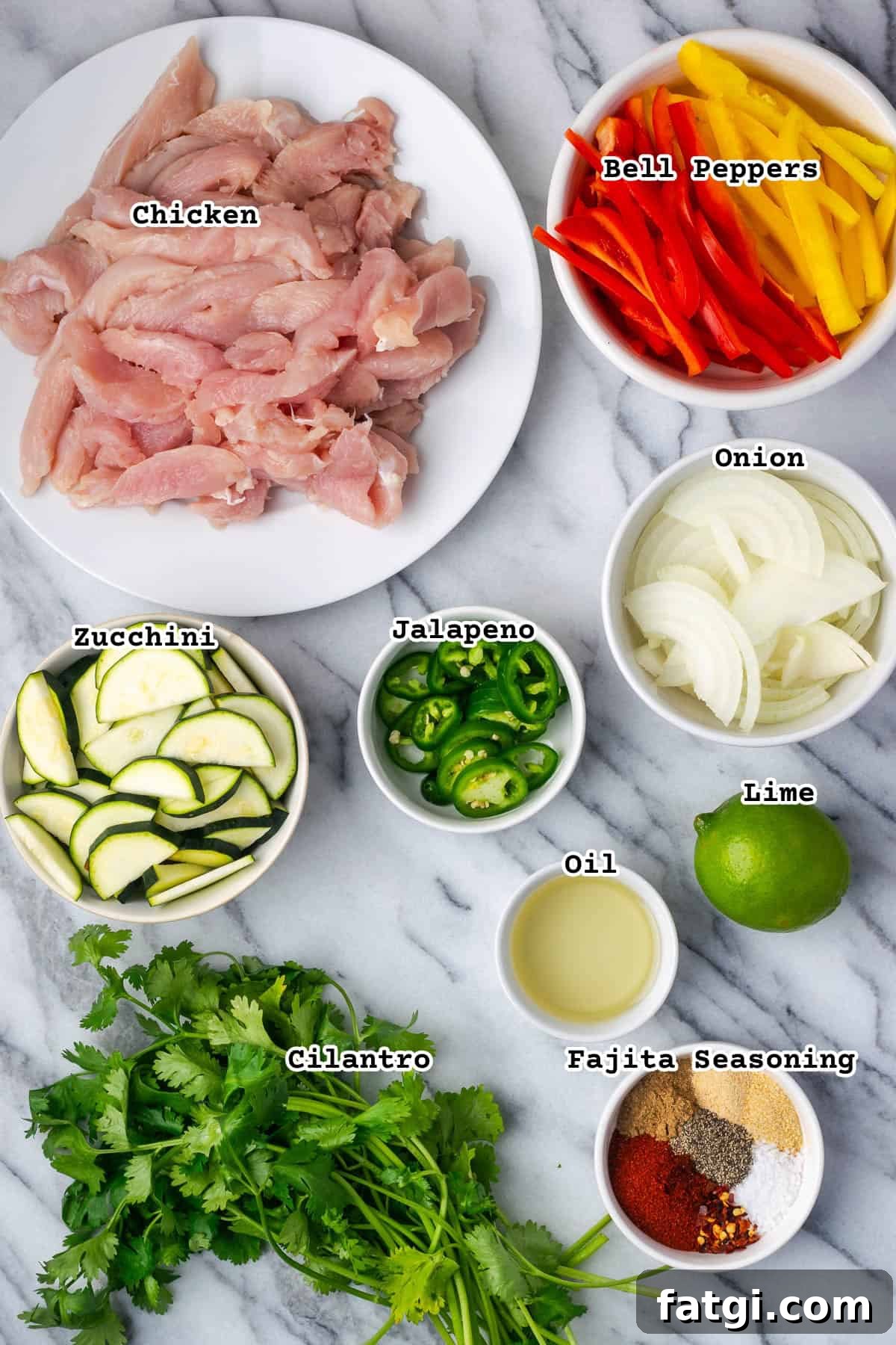 Sheet Pan Chicken Fajitas with Peppers and Onions 3 Ingredients for sheet pan chicken fajitas sitting on a marble counter.