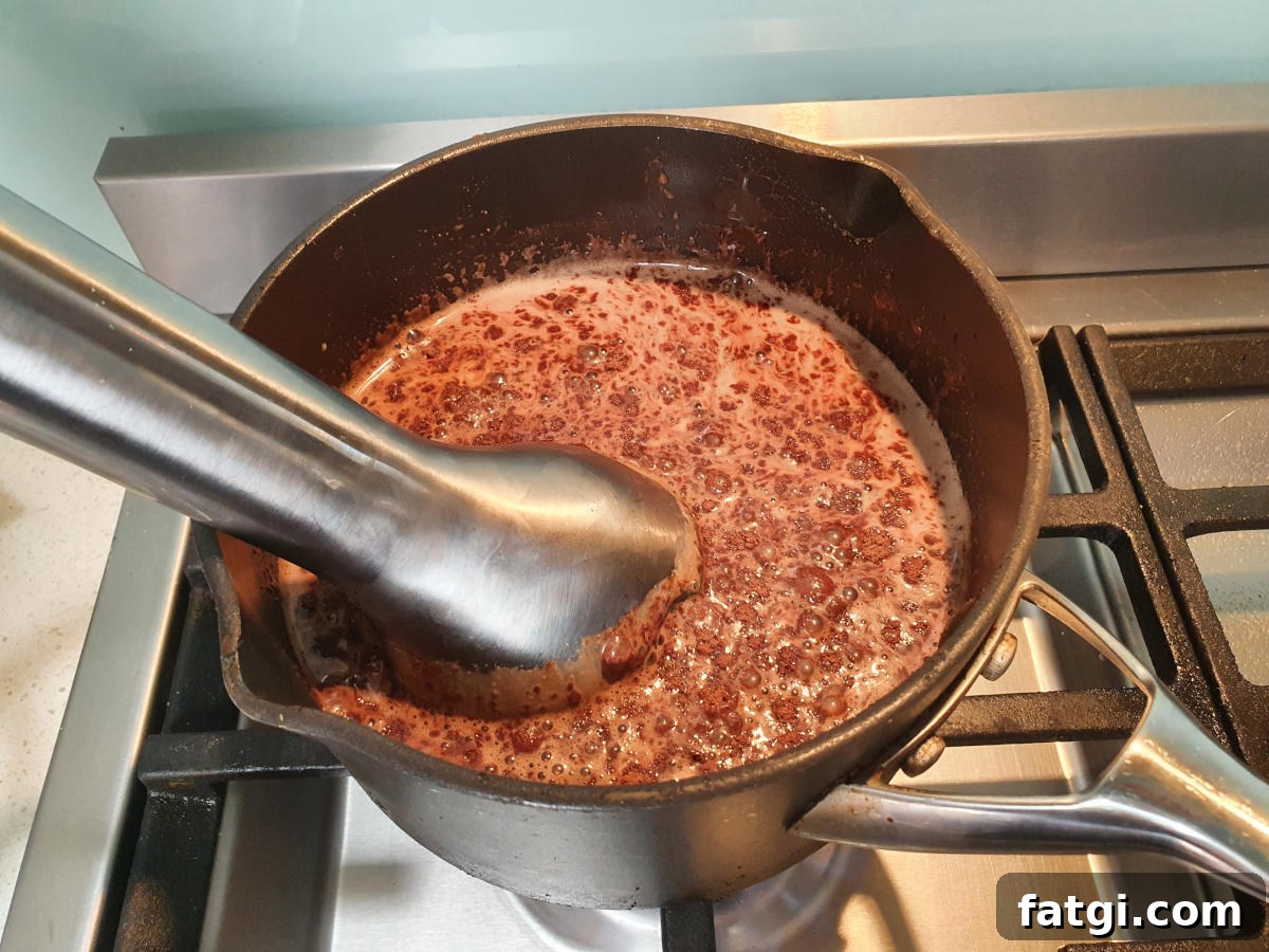 blending ice cream mix with an immersion blender.