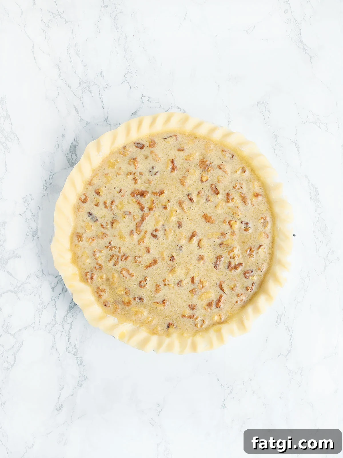 unbaked Kentucky Derby pie on a white marble background
