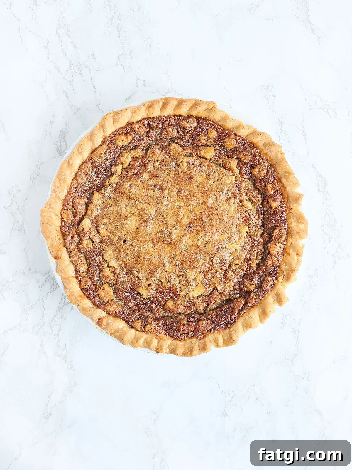 baked Kentucky Derby pie on a white marble background