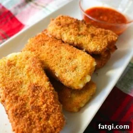 Mozzarella sticks on a white plate.