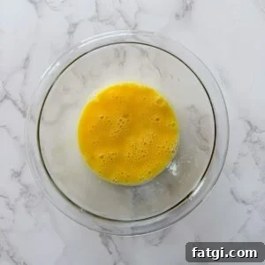 Eggs whisked in a bowl.